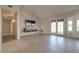 Living room with tile flooring, mounted TV and hallway access at 1354 E Brentrup Dr, Tempe, AZ 85283