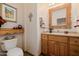 Charming bathroom with wooden vanity and decorative mirror at 17022 E Player Ct, Fountain Hills, AZ 85268