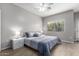 Bright bedroom with wood-look floors, plush bed, and ceiling fan at 1718 W Colter St # 193, Phoenix, AZ 85015