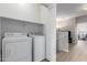 Bright laundry room with washer, dryer, and extra shelving at 1718 W Colter St # 193, Phoenix, AZ 85015