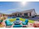 Inviting backyard with a pool, patio, and cozy seating area, perfect for outdoor relaxation and entertaining under sunny skies at 17844 E Pacana Ct, Gold Canyon, AZ 85118