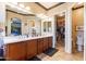 Elegant bathroom with double sinks, spacious counters and cabinets, bright lighting and a doorway to closet at 17844 E Pacana Ct, Gold Canyon, AZ 85118