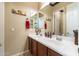 Bathroom featuring double sinks with framed mirrors, wood cabinets, and neutral paint at 17844 E Pacana Ct, Gold Canyon, AZ 85118