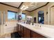 Bright bathroom features double sinks with cabinet storage, a large mirror and a soaking tub at 17844 E Pacana Ct, Gold Canyon, AZ 85118