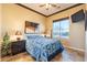 Bedroom featuring tile floors, a ceiling fan and a nightstand with lamp providing ambient light at 17844 E Pacana Ct, Gold Canyon, AZ 85118