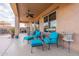 Relaxing covered patio featuring comfortable seating and outdoor dining options, ideal for enjoying the fresh air at 17844 E Pacana Ct, Gold Canyon, AZ 85118