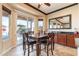 Dining room with sliding glass doors to the back yard, stylish seating and wet bar at 17844 E Pacana Ct, Gold Canyon, AZ 85118