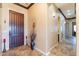 Inviting entryway with a solid wood door, decorative accents, and ceramic tile flooring at 17844 E Pacana Ct, Gold Canyon, AZ 85118