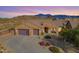 Expansive desert home boasting a three-car garage and picturesque mountain views, blending luxury with natural beauty at 17844 E Pacana Ct, Gold Canyon, AZ 85118