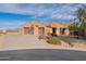 Inviting single-story home with desert landscaping, dual garage doors, and a well-maintained yard at 17844 E Pacana Ct, Gold Canyon, AZ 85118