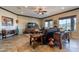 Spacious living room featuring tile floors, a ceiling fan, and views of the surrounding landscape at 17844 E Pacana Ct, Gold Canyon, AZ 85118