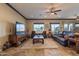 Open living room design featuring tile floors, large windows, and a ceiling fan at 17844 E Pacana Ct, Gold Canyon, AZ 85118