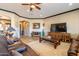 Comfortable living room boasting tile flooring, a ceiling fan, and stylish decor at 17844 E Pacana Ct, Gold Canyon, AZ 85118