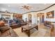 Bright living area with tile floors, leather furniture, and seamless flow to the kitchen at 17844 E Pacana Ct, Gold Canyon, AZ 85118