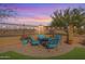 Inviting outdoor patio with stylish seating and desert landscaping, perfect for relaxing and enjoying the beautiful sunsets at 17844 E Pacana Ct, Gold Canyon, AZ 85118