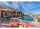 Back yard pool with shaded patio and several seating areas at 17844 E Pacana Ct, Gold Canyon, AZ 85118