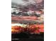 A vibrant Arizona sunset paints the sky in shades of orange and pink at 17844 E Pacana Ct, Gold Canyon, AZ 85118