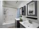 Bathroom with double sinks, a shower, and a tub at 1801 E Aire Libre Ave, Phoenix, AZ 85022