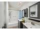 Well-lit bathroom with double sinks and a shower-tub combination at 1801 E Aire Libre Ave, Phoenix, AZ 85022