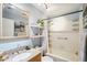 Cozy bathroom with a shower-tub combo and granite countertop at 1801 E Aire Libre Ave, Phoenix, AZ 85022