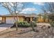 Charming single-story home featuring a two-car garage and xeriscaped front yard with desert landscaping and mature cacti at 1801 E Aire Libre Ave, Phoenix, AZ 85022