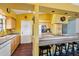 Bright, open kitchen featuring a breakfast bar, laminate countertops, wood cabinets, and hardwood floors at 1801 E Aire Libre Ave, Phoenix, AZ 85022