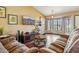 Comfortable living room with a large television and lots of natural light from the bay windows at 1801 E Aire Libre Ave, Phoenix, AZ 85022