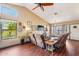 Comfortable living room featuring hardwood floors, a fan, and views of the front yard at 1801 E Aire Libre Ave, Phoenix, AZ 85022