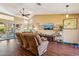 Vaulted ceilings, a ceiling fan, and a large window highlight this spacious living room at 1801 E Aire Libre Ave, Phoenix, AZ 85022