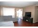 Living room with gray sectional sofa and wood flooring at 1914 N Lebaron --, Mesa, AZ 85201