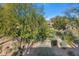 Landscaped backyard with mature trees and lawn at 19550 N Grayhawk Dr # 1107, Scottsdale, AZ 85255