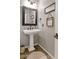 Elegant bathroom with pedestal sink and decorative mirror at 19550 N Grayhawk Dr # 1107, Scottsdale, AZ 85255