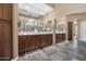 Elegant bathroom with double vanity and large mirror at 19550 N Grayhawk Dr # 1107, Scottsdale, AZ 85255