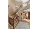 Grand curved staircase with wood railing and neutral carpet at 19550 N Grayhawk Dr # 1107, Scottsdale, AZ 85255