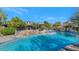 Relaxing community pool with waterfall and lounge chairs at 19550 N Grayhawk Dr # 1107, Scottsdale, AZ 85255