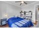 Bedroom with blue bedding, ceiling fan, and storage at 19646 E Reins Rd, Queen Creek, AZ 85142