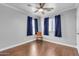 Bedroom with hardwood floors and blue curtains at 19646 E Reins Rd, Queen Creek, AZ 85142