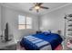 Bedroom with blue bedding and a ceiling fan at 19646 E Reins Rd, Queen Creek, AZ 85142