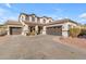 Two-story house with a three-car garage and landscaping at 19646 E Reins Rd, Queen Creek, AZ 85142