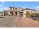 Two-story house with a three-car garage and landscaping at 19646 E Reins Rd, Queen Creek, AZ 85142