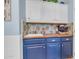 Small kitchen with blue cabinets and wood countertops at 19646 E Reins Rd, Queen Creek, AZ 85142