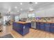 Spacious kitchen with island, white and blue cabinets, and wood countertops at 19646 E Reins Rd, Queen Creek, AZ 85142