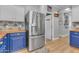 Modern kitchen with stainless steel fridge and blue cabinetry at 19646 E Reins Rd, Queen Creek, AZ 85142