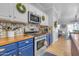 Kitchen with wood countertops, blue cabinets, and a view to dining area at 19646 E Reins Rd, Queen Creek, AZ 85142