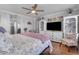 Main bedroom with king bed, built-in shelving and hardwood floors at 19646 E Reins Rd, Queen Creek, AZ 85142