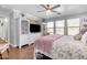 Main bedroom with king bed, built-in shelving and hardwood floors at 19646 E Reins Rd, Queen Creek, AZ 85142