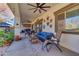 Relaxing covered patio with comfortable seating and ceiling fan at 19646 E Reins Rd, Queen Creek, AZ 85142