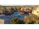 Aerial view of a community pool area with lounge chairs, pergola, spa, and well-maintained landscaping at 19777 N 76Th St # 2292, Scottsdale, AZ 85255