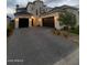 Luxury home exterior with three-car garage at 20684 E Natalie Way, Queen Creek, AZ 85142