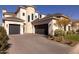 Front view of a luxurious home with a large driveway and landscaping at 20684 E Natalie Way, Queen Creek, AZ 85142